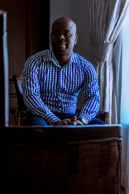 Man stretching by his home office desk, looking calm and relaxed